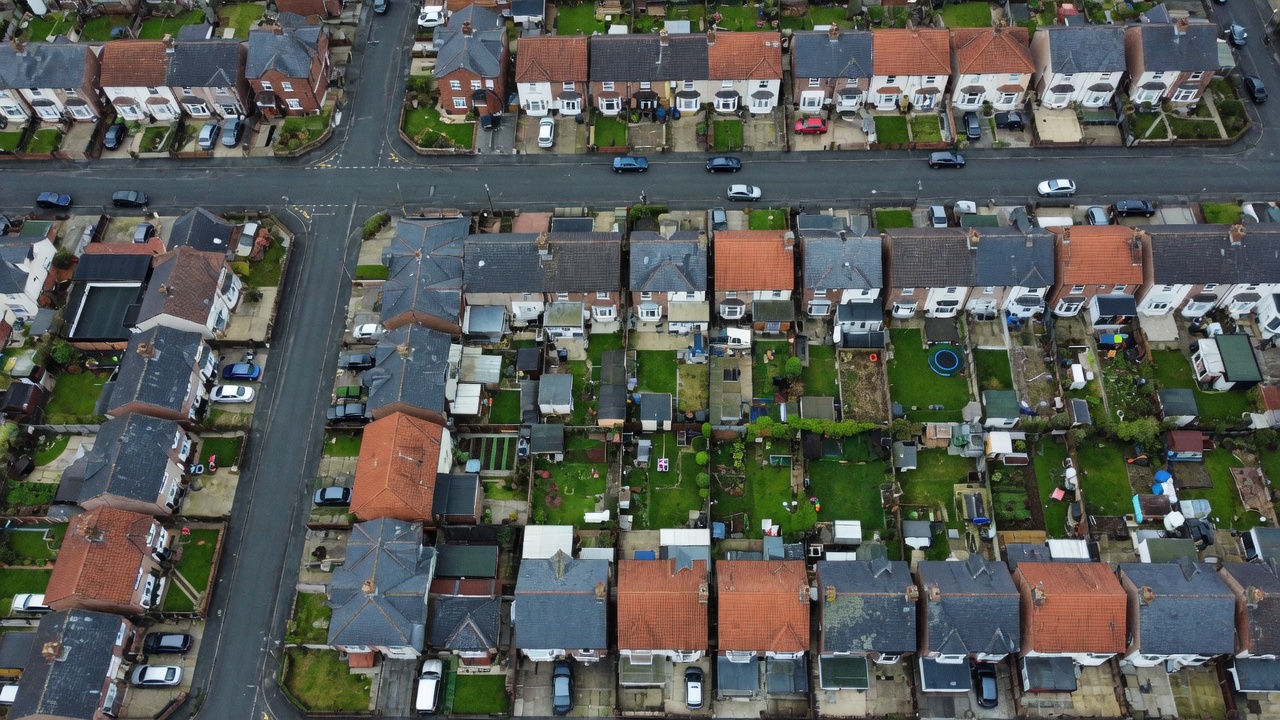 Aerial view of slate and tile rooftops on a British housing estate